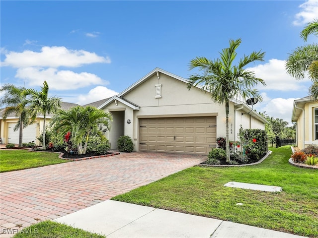 view of front of house with a garage, a front lawn, decorative driveway, and stucco siding