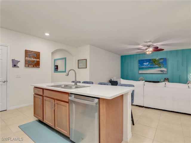 kitchen with dishwasher, open floor plan, light tile patterned flooring, and a sink