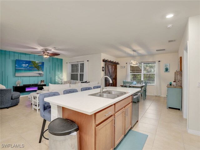 kitchen with dishwasher, visible vents, open floor plan, and a sink