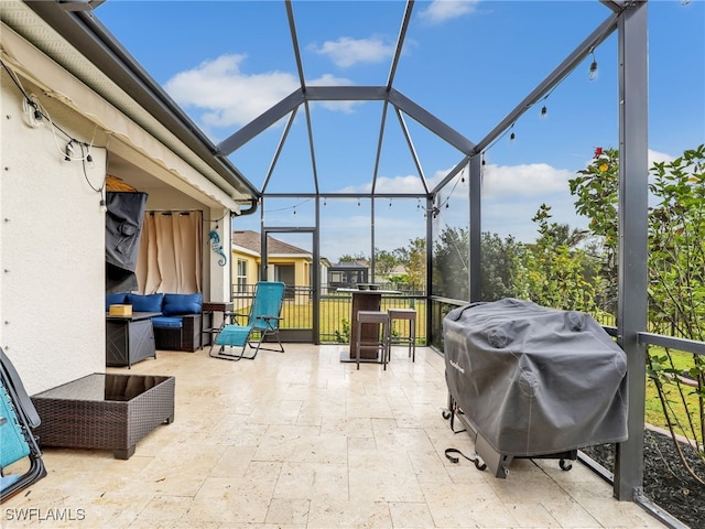 view of patio with glass enclosure, outdoor lounge area, and grilling area