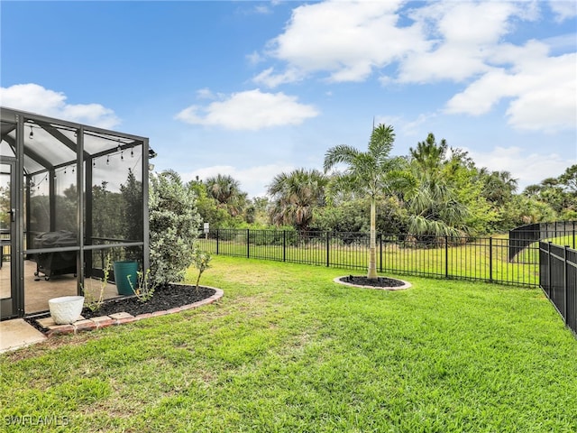 view of yard featuring a lanai and a fenced backyard