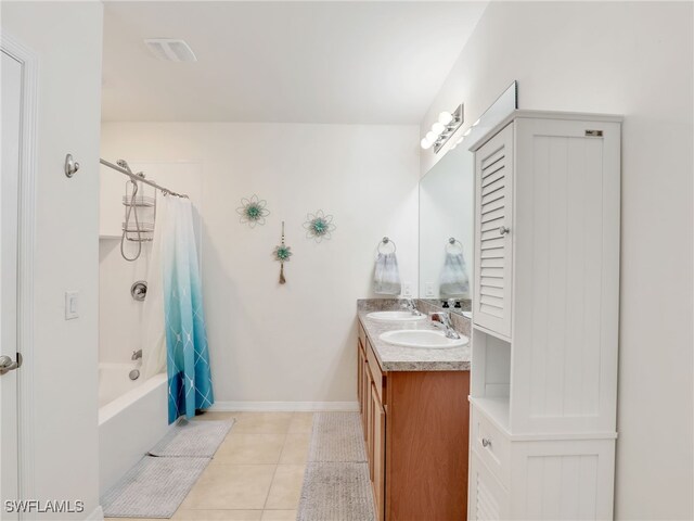 full bathroom featuring double vanity, shower / bath combo, a sink, and tile patterned floors