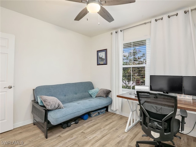 office area with a ceiling fan, baseboards, and light wood finished floors