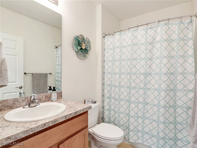 full bathroom featuring toilet and vanity