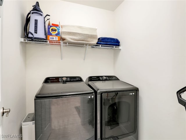 clothes washing area with laundry area and washer and dryer