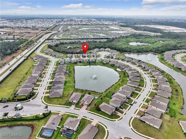 drone / aerial view with a water view and a residential view