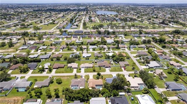 drone / aerial view with a residential view and a water view