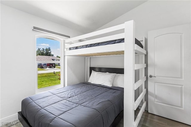 bedroom featuring lofted ceiling and wood finished floors