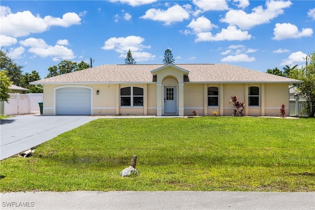 ranch-style home with stucco siding, an attached garage, fence, driveway, and a front lawn