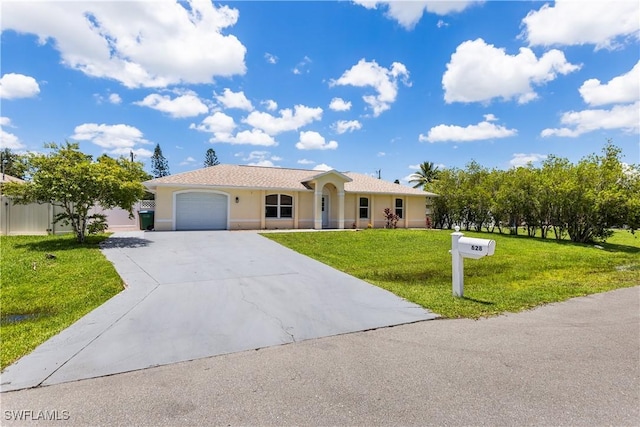 ranch-style home featuring an attached garage, fence, concrete driveway, stucco siding, and a front lawn