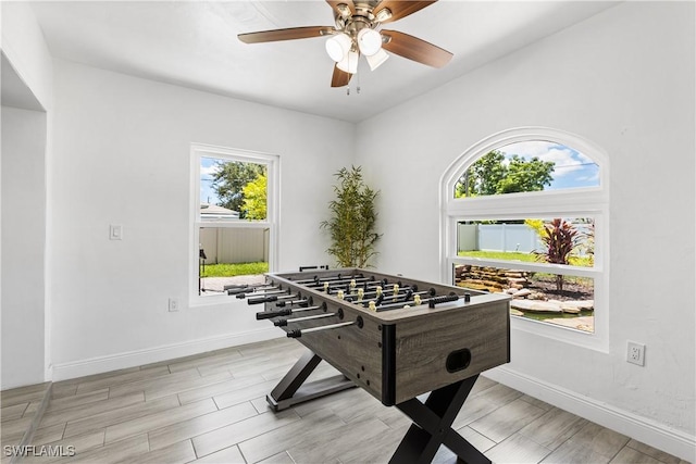 rec room with ceiling fan, wood tiled floor, and baseboards