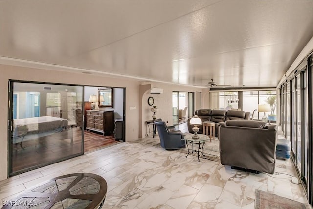 living area featuring marble finish floor and a wall mounted air conditioner