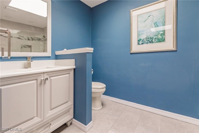 full bath featuring a stall shower, baseboards, toilet, tile patterned floors, and vanity