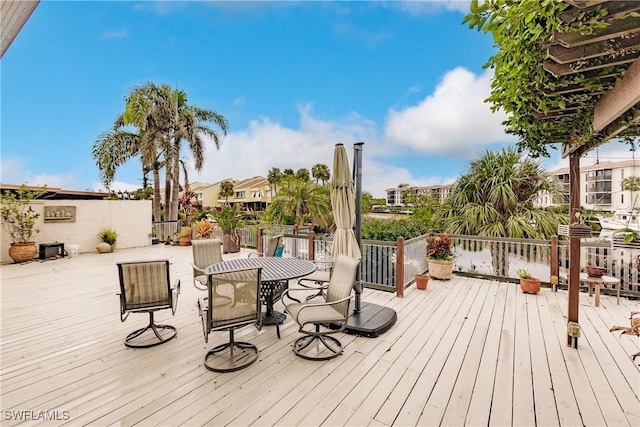 wooden terrace featuring outdoor dining area