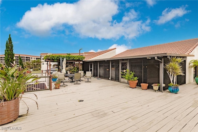 wooden deck featuring a sunroom