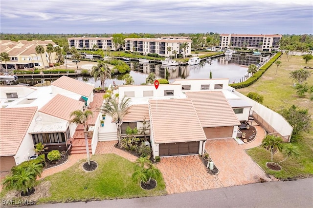 drone / aerial view with a water view and a residential view