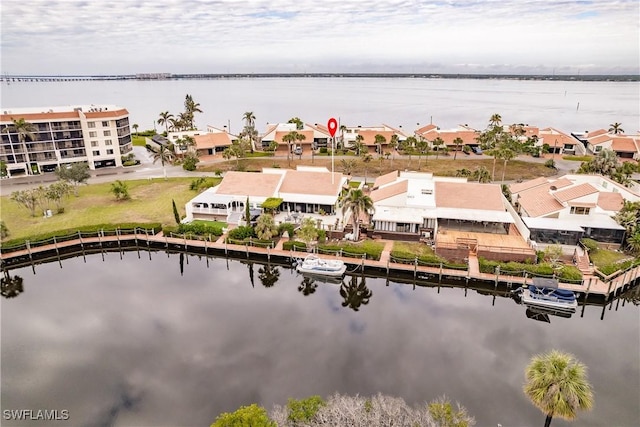 bird's eye view featuring a water view and a residential view