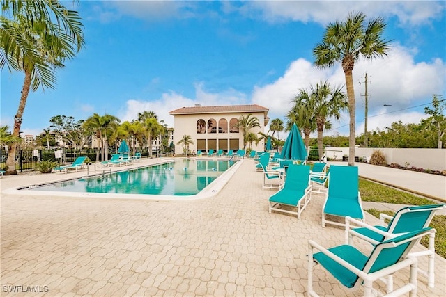 pool featuring a patio area and fence