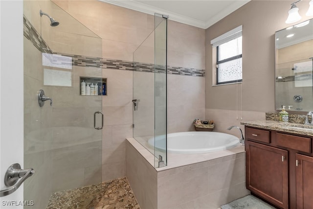 bathroom featuring a stall shower, ornamental molding, a garden tub, and vanity