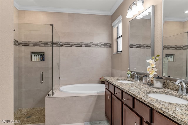 bathroom featuring a garden tub, a shower stall, ornamental molding, and a sink