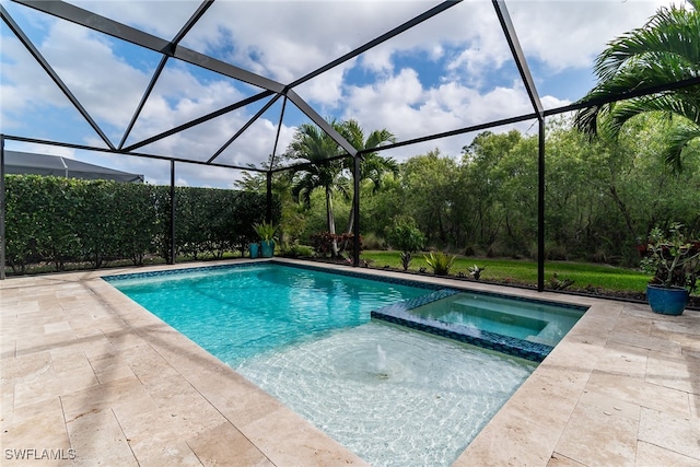 view of pool with a pool with connected hot tub, glass enclosure, and a patio