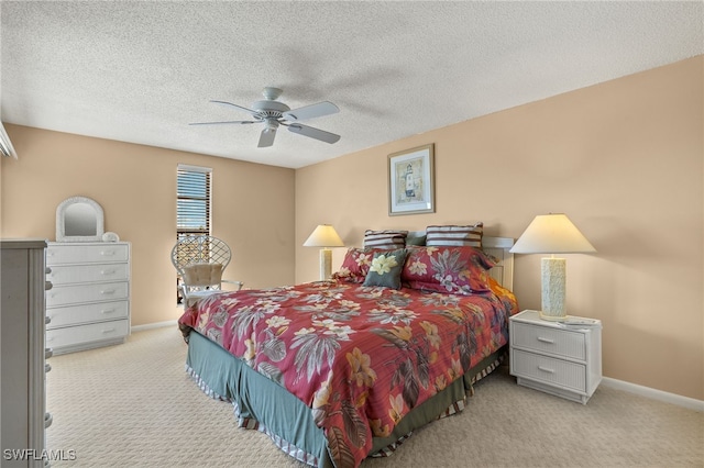 bedroom featuring carpet floors, a ceiling fan, baseboards, and a textured ceiling