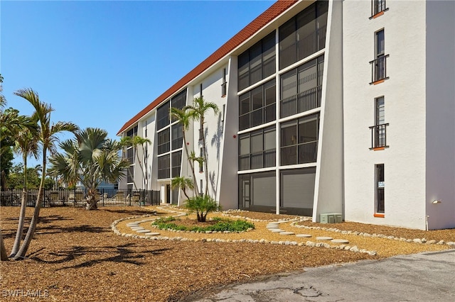 view of building exterior featuring fence