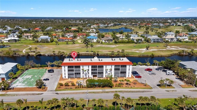 aerial view with a water view, view of golf course, and a residential view