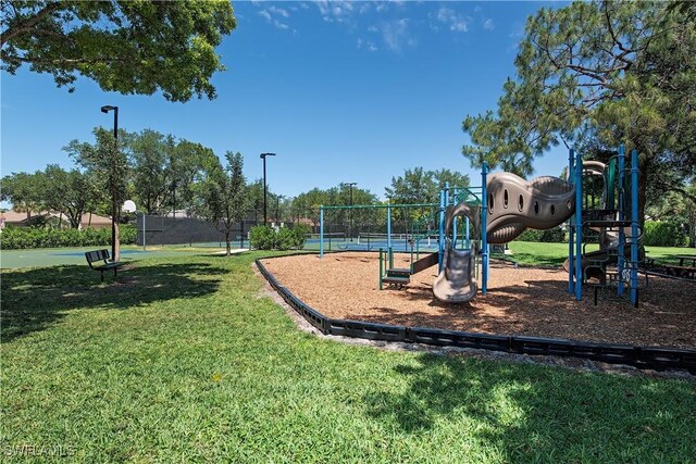 community jungle gym with a lawn