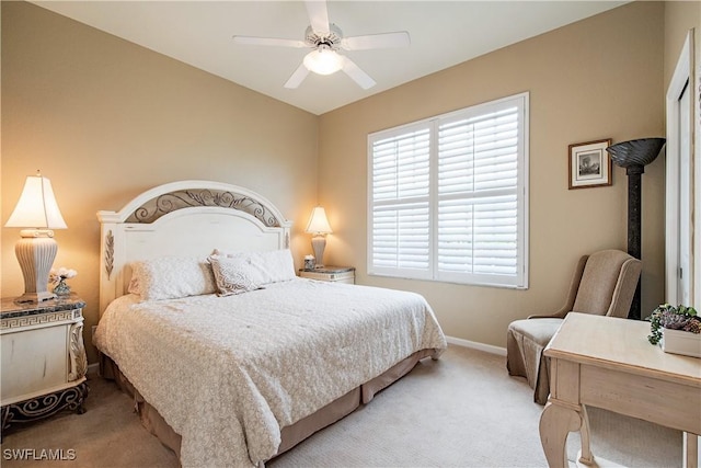 bedroom featuring baseboards, a ceiling fan, and light colored carpet