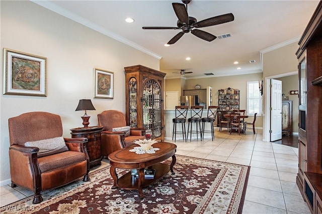 living area with light tile patterned floors, baseboards, visible vents, and crown molding