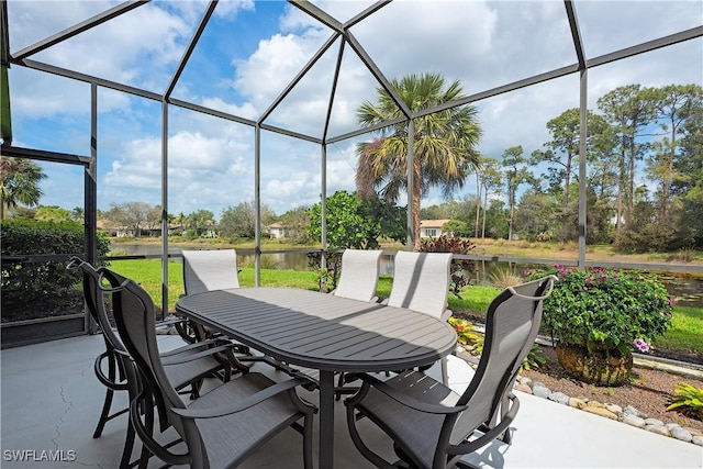 view of patio featuring outdoor dining area and glass enclosure