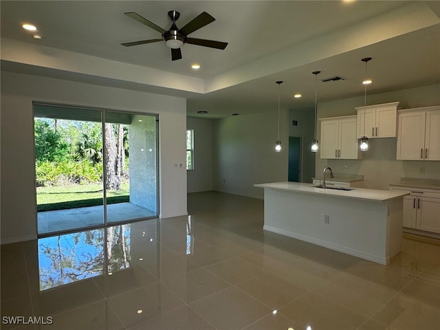 kitchen featuring white cabinets, recessed lighting, visible vents, and a sink