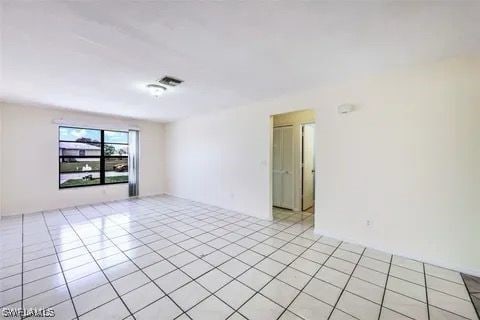 spare room with light tile patterned flooring and visible vents