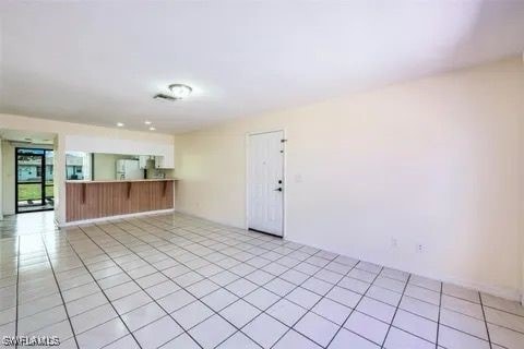 spare room with light tile patterned floors