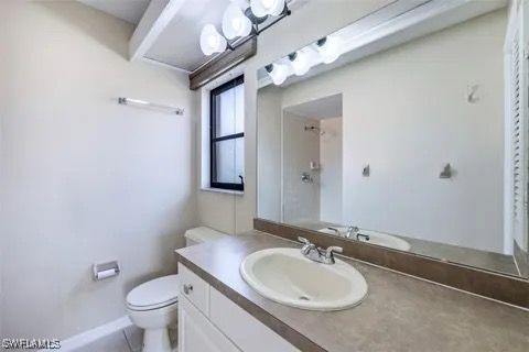 bathroom featuring vanity and toilet