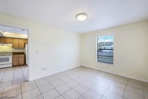 unfurnished room with light tile patterned floors