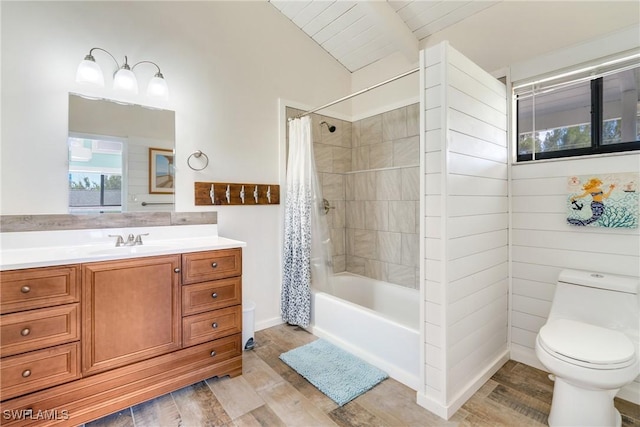 full bathroom featuring shower / tub combo with curtain, toilet, vaulted ceiling, vanity, and wood finished floors