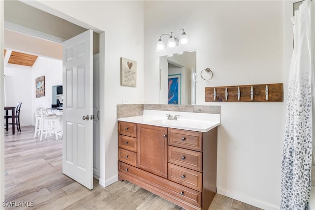 bathroom with wood finished floors and vanity