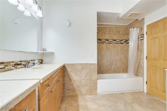 bathroom featuring shower / tub combo, vanity, and tile walls