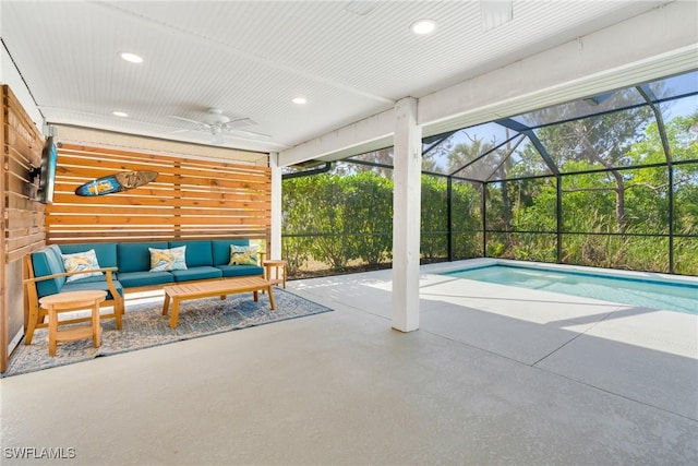 pool with an outdoor hangout area, a patio area, a lanai, and a ceiling fan