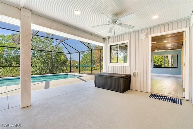 outdoor pool with a patio, a lanai, and a ceiling fan