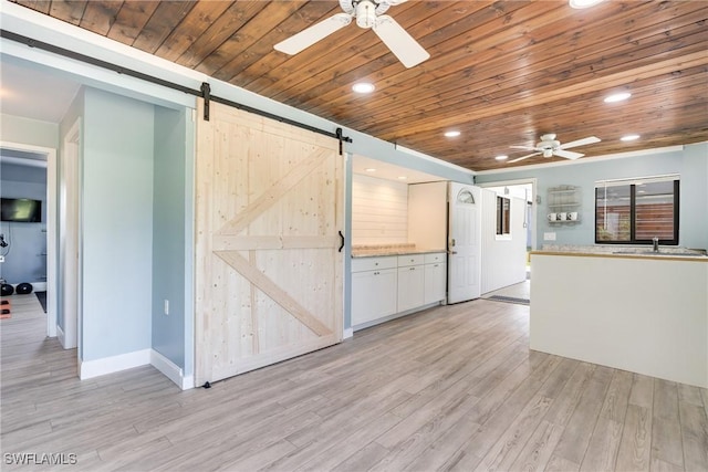 interior space featuring light wood finished floors, recessed lighting, a barn door, wood ceiling, and ceiling fan