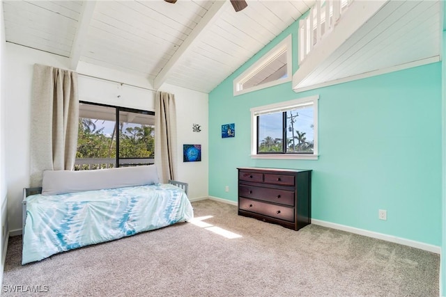 carpeted bedroom featuring lofted ceiling with beams, a ceiling fan, and baseboards