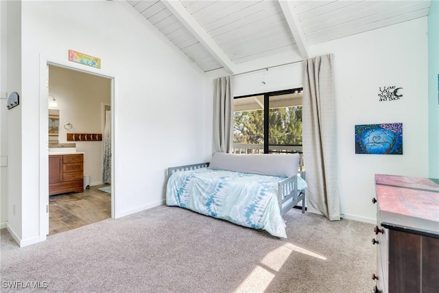 bedroom with lofted ceiling with beams, ensuite bath, baseboards, and carpet flooring