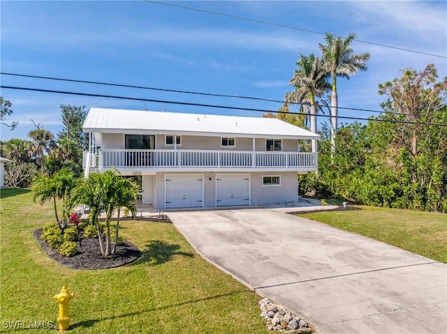 view of front of house featuring an attached garage, a front lawn, and concrete driveway