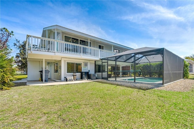 back of property with glass enclosure, central air condition unit, a yard, an outdoor pool, and a patio area