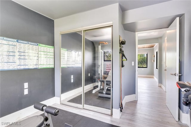 interior space with baseboards and wood finished floors