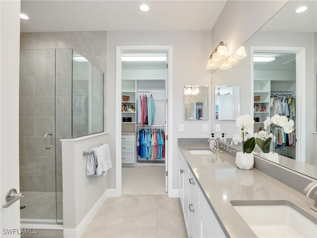 full bath with a stall shower, double vanity, a sink, and recessed lighting