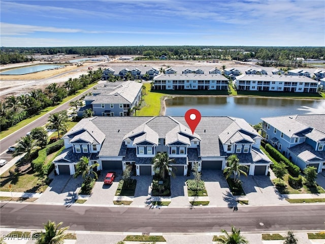 drone / aerial view featuring a residential view and a water view